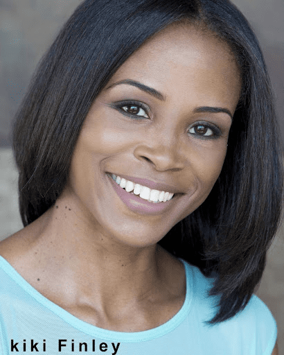 A woman with black hair smiles for the camera.