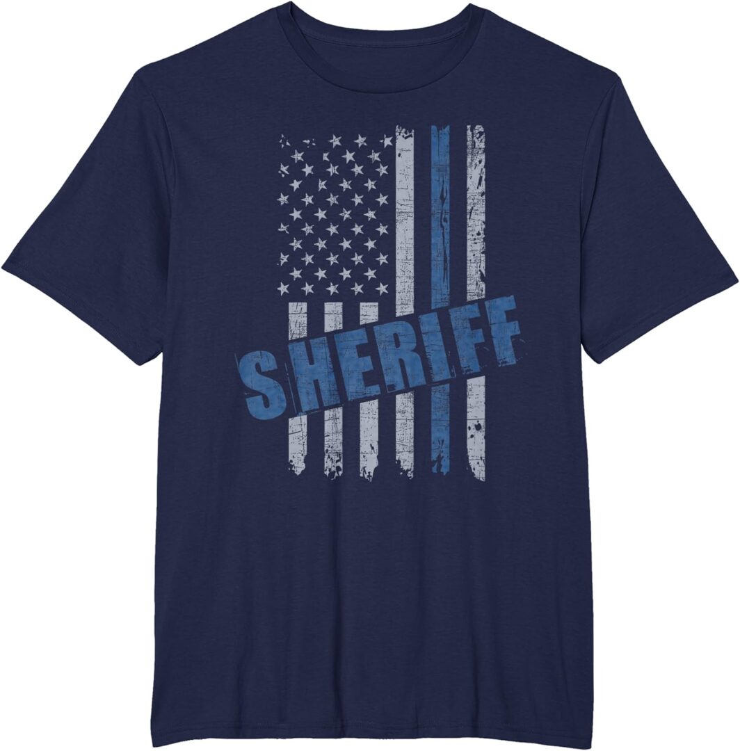 A police officer is wearing a shirt with the word sheriff on it.